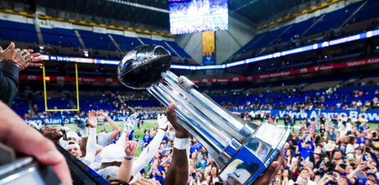 BYU gets a blowout victory over Colorado (36-14). Players celebrate with the Alamo Bowl trophy.