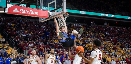 BYU's Dallin Hall dunks the ball against Iowa State. No. 23 BYU went on to beat No. 10 Iowa State 88-85.